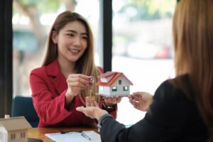 Mortgage broker handing over house keys to a client