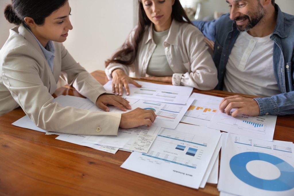 A mortgage broker sitting with a couple to review why their refinance application was declined