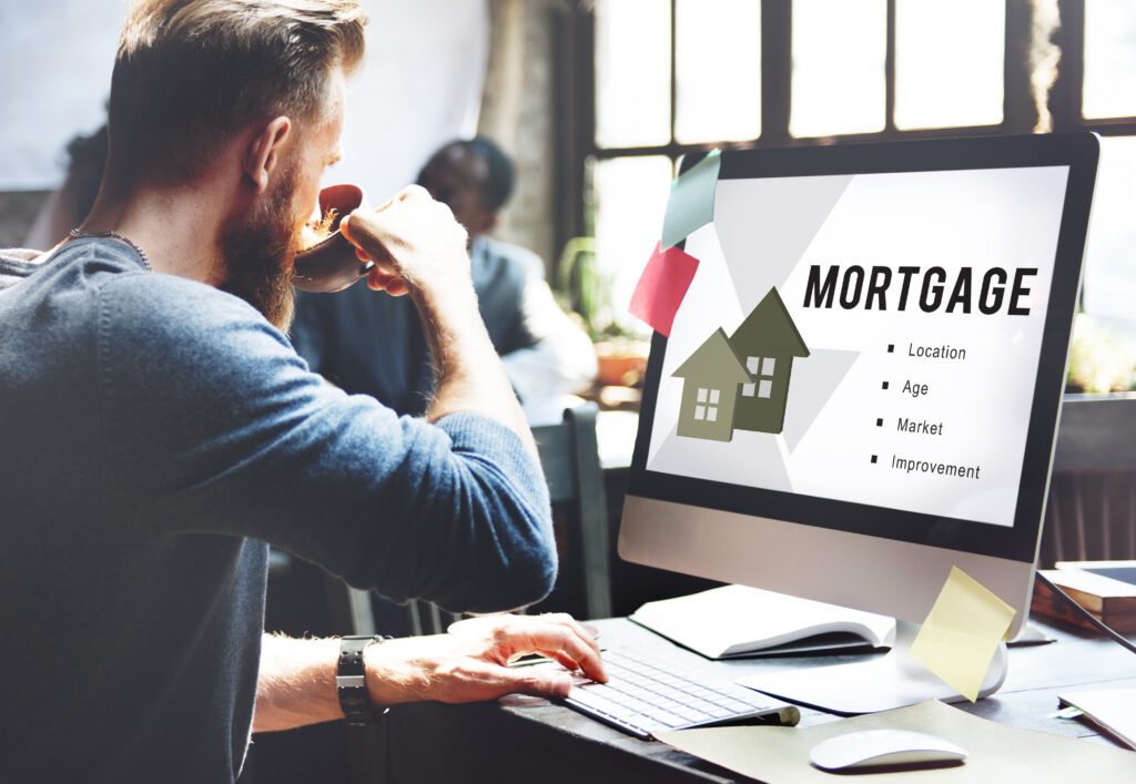 A finance broker and client reviewing loan paperwork together